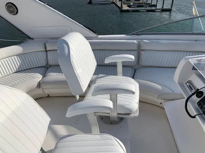  Yacht Photos Pics 1999 Bayliner 5788 Pilot House Motoryacht cockpit with white seating and helm controls.
