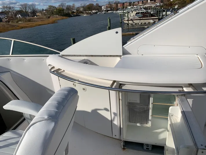  Yacht Photos Pics 1999 Bayliner 5788 Pilot House Motoryacht deck with seating and water view.