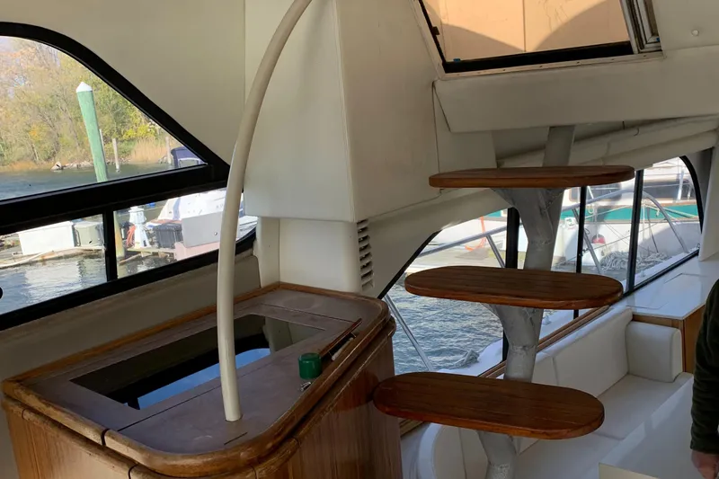  Yacht Photos Pics Interior of 1999 Bayliner 5788 Pilot House Motoryacht with spiral staircase and large windows.