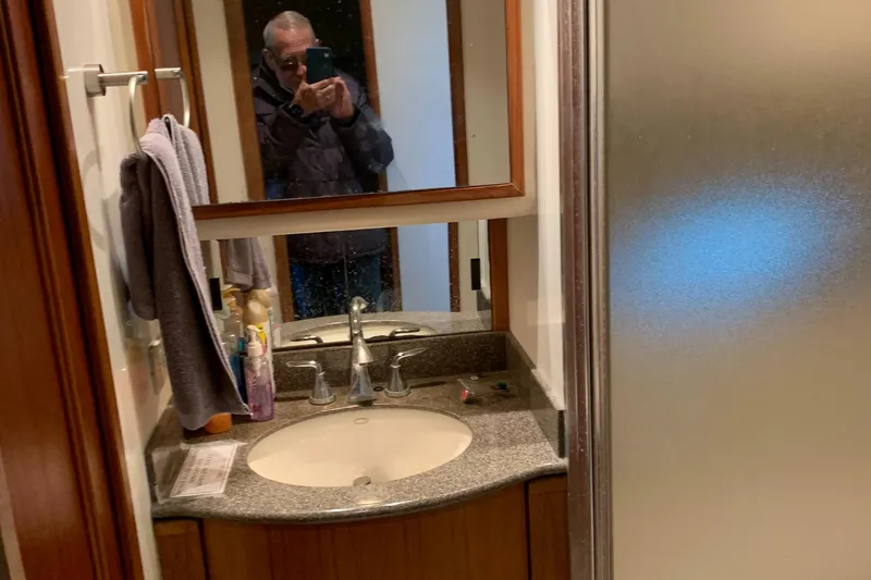  Yacht Photos Pics Bathroom interior of 1999 Bayliner 5788 Pilot House Motoryacht with sink and mirror.