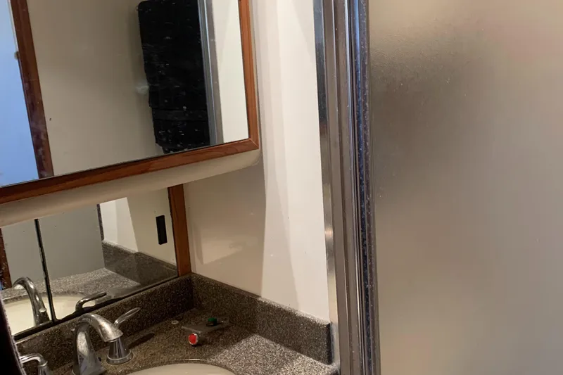  Yacht Photos Pics Bathroom interior of 1999 Bayliner 5788 Pilot House Motoryacht with sink and shower.