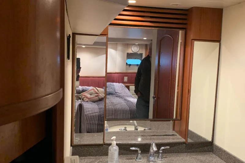  Yacht Photos Pics 1999 Bayliner 5788 Pilot House Motoryacht interior with bedroom and bathroom vanity.