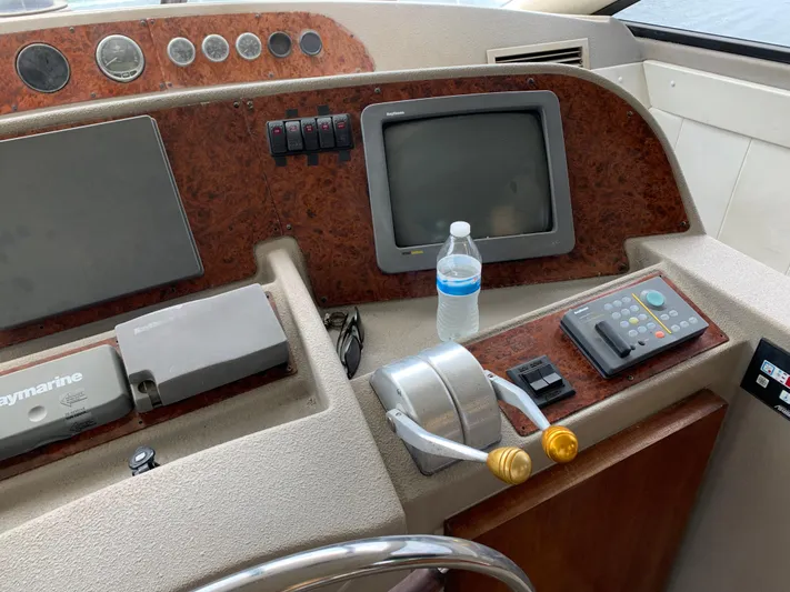  Yacht Photos Pics 1999 Bayliner 5788 Pilot House Motoryacht helm with controls and navigation equipment.