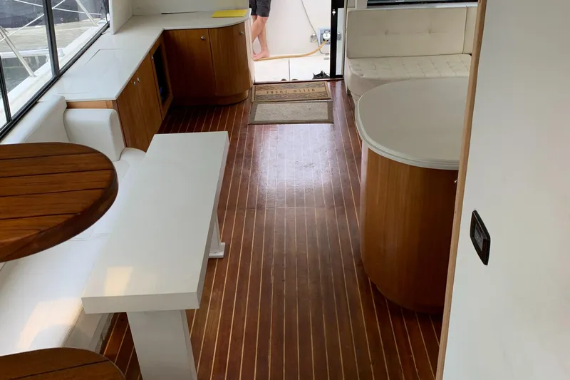  Yacht Photos Pics 1999 Bayliner 5788 Pilot House Motoryacht interior with wood flooring and modern furnishings.