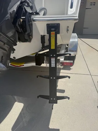  Yacht Photos Pics 2020 Pursuit DC 266 Dual Console boat with a mounted ladder on a trailer.