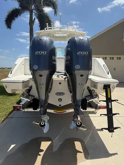  Yacht Photos Pics 2020 Pursuit DC 266 Dual Console boat with twin Yamaha 200 engines, parked outdoors.