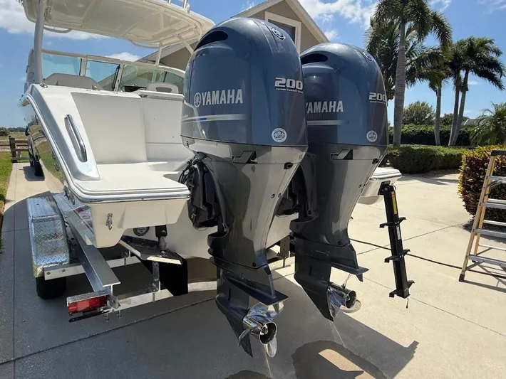  Yacht Photos Pics 2020 Pursuit DC 266 Dual Console with twin Yamaha 200 engines, parked outdoors.