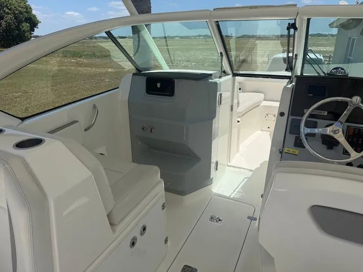  Yacht Photos Pics 2020 Pursuit DC 266 Dual Console boat interior with seating and steering wheel.