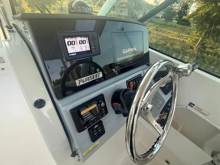  Yacht Photos Pics 2020 Pursuit DC 266 Dual Console boat dashboard with Garmin display and steering wheel.