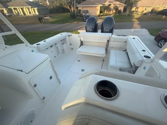  Yacht Photos Pics 2020 Pursuit DC 266 Dual Console boat interior with seating and storage compartments.