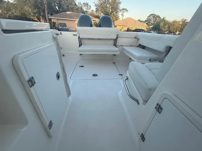  Yacht Photos Pics 2020 Pursuit DC 266 Dual Console boat interior with seating and storage compartments.