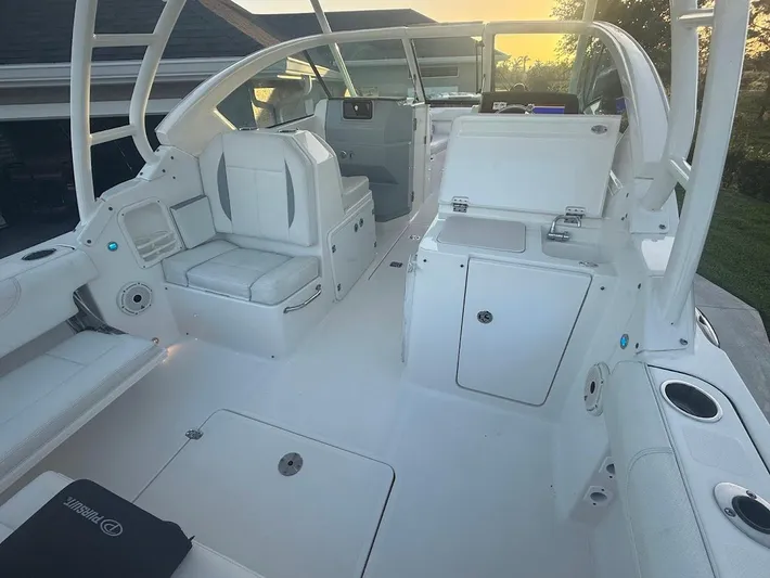  Yacht Photos Pics 2020 Pursuit DC 266 Dual Console boat interior with white seating and storage compartments.