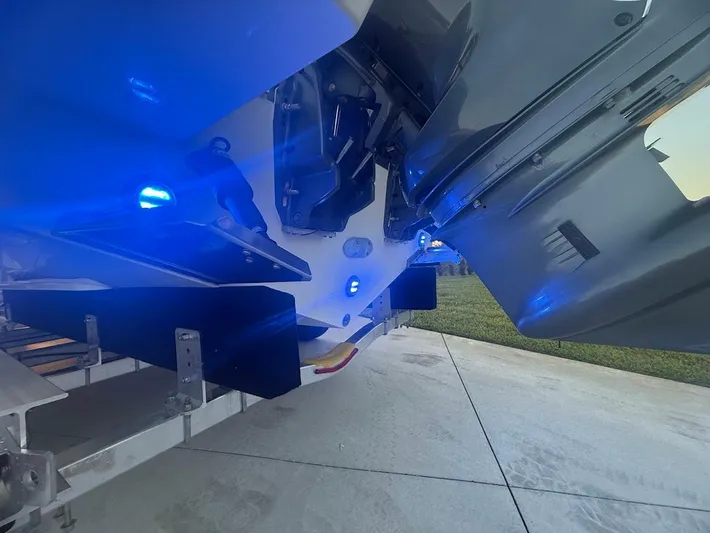  Yacht Photos Pics 2020 Pursuit DC 266 Dual Console boat with blue LED lights on a trailer.