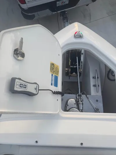  Yacht Photos Pics 2020 Pursuit DC 266 Dual Console boat anchor compartment with control panel and key.