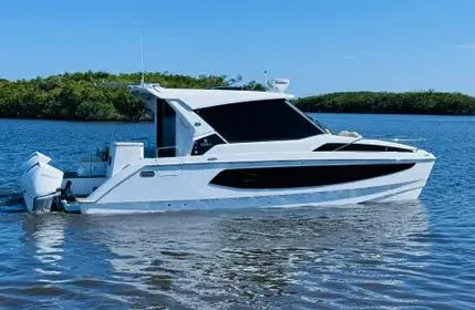  Yacht Photos Pics 2023 Aquila 36 Sport boat on calm water, sleek design, sunny day.
