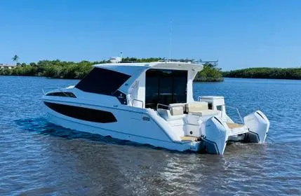  Yacht Photos Pics 2023 Aquila 36 Sport boat on calm water, featuring sleek design and modern amenities.