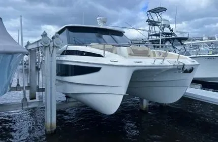  Yacht Photos Pics 2023 Aquila 36 Sport catamaran docked, showcasing sleek design and modern features.