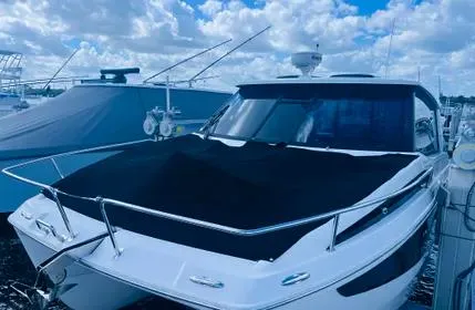  Yacht Photos Pics 2023 Aquila 36 Sport yacht docked under a cloudy sky.