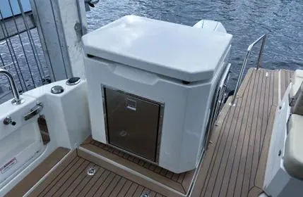  Yacht Photos Pics 2023 Aquila 36 Sport boat deck with storage compartment and seating area.