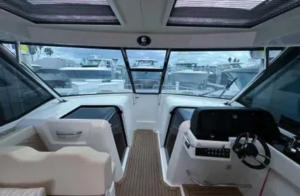  Yacht Photos Pics Interior view of 2023 Aquila 36 Sport boat cockpit with modern controls and seating.