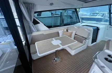  Yacht Photos Pics Interior of 2023 Aquila 36 Sport yacht with seating and table.