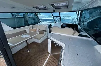  Yacht Photos Pics Interior of 2023 Aquila 36 Sport yacht with seating and helm station.