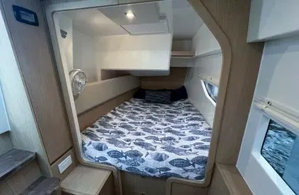  Yacht Photos Pics 2023 Aquila 36 Sport cabin interior with bed and window view.