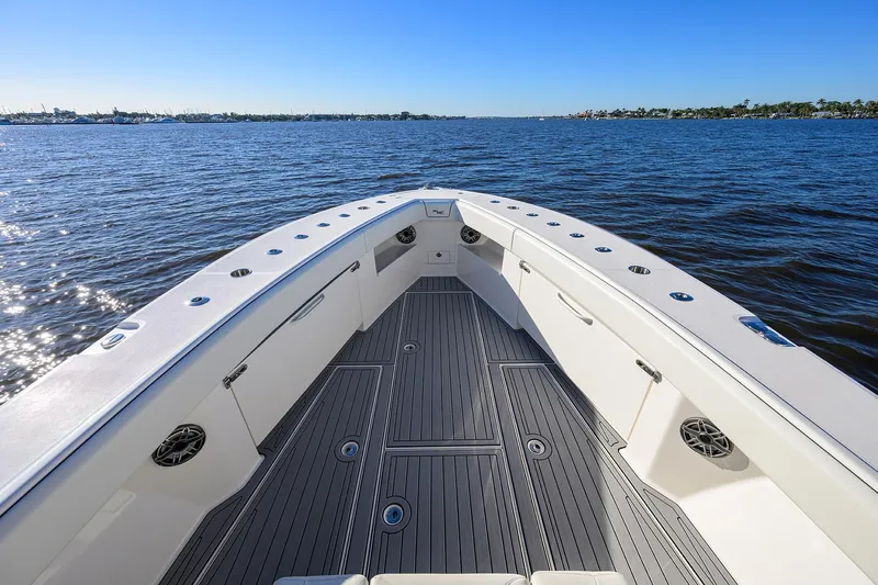 Barefoot In Public Yacht Photos Pics 2023 SeaVee 370Z boat deck with ocean view, clear sky, and sleek design.