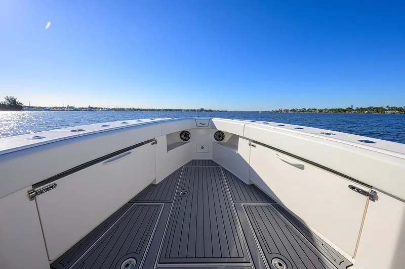 Barefoot In Public Yacht Photos Pics 2023 SeaVee 370Z boat deck with ocean view under clear blue sky.