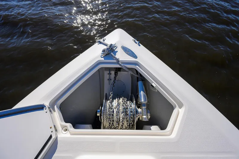 Barefoot In Public Yacht Photos Pics 2023 SeaVee 370Z boat anchor compartment with chain, on calm water.