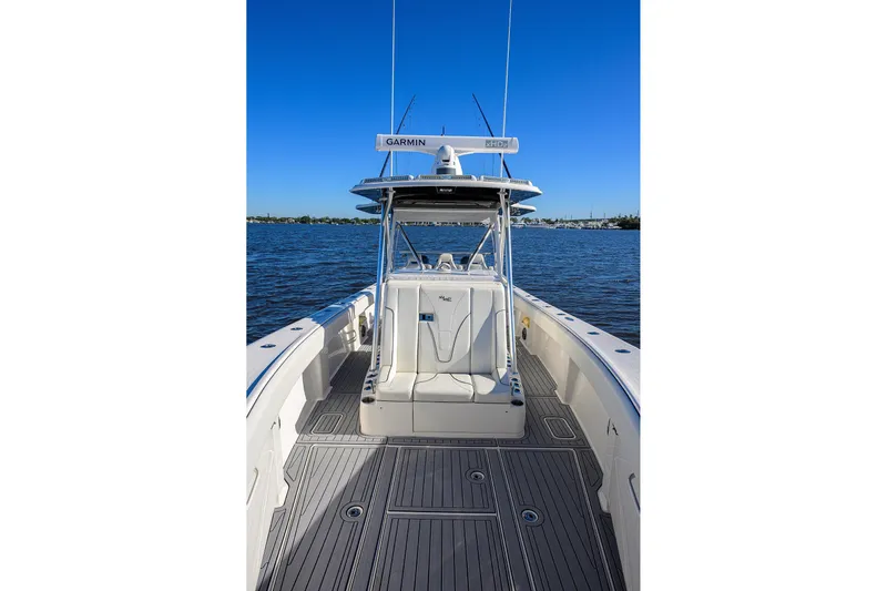 Barefoot In Public Yacht Photos Pics 2023 SeaVee 370Z boat on water, featuring spacious deck and advanced navigation equipment.