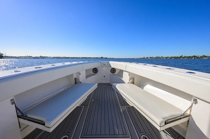 Barefoot In Public Yacht Photos Pics 2023 SeaVee 370Z boat interior with seating, overlooking calm waters and clear blue sky.