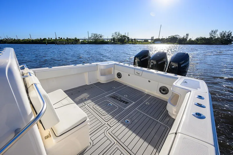 Barefoot In Public Yacht Photos Pics 2023 SeaVee 370Z boat deck with triple Mercury engines on a sunny day.