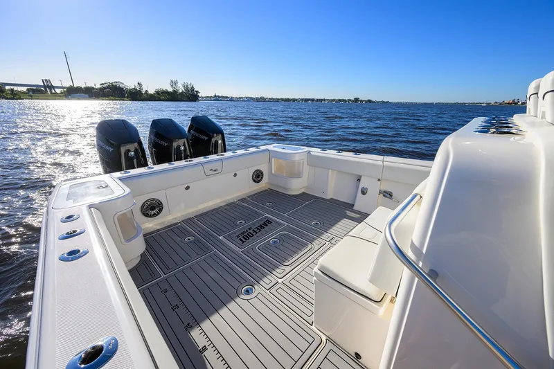 Barefoot In Public Yacht Photos Pics 2023 SeaVee 370Z boat deck with triple Mercury engines on a sunny day.