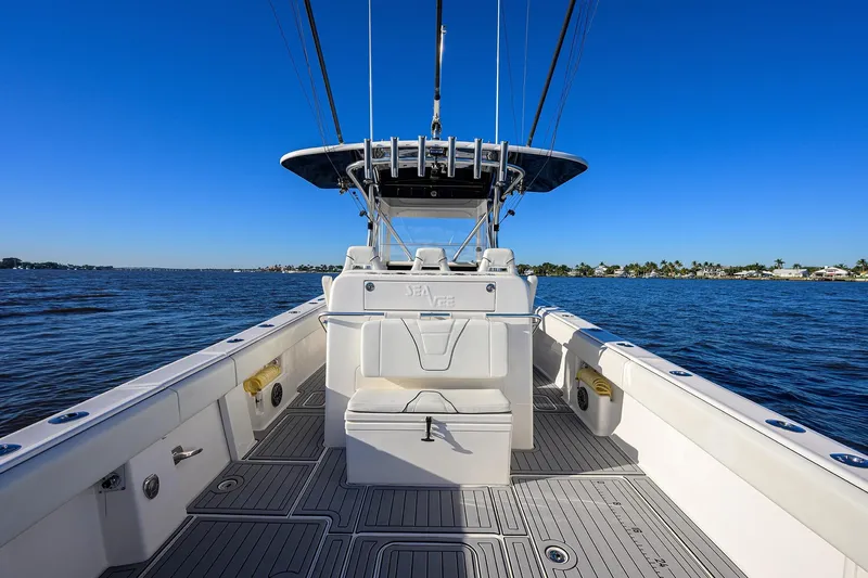 Barefoot In Public Yacht Photos Pics 2023 SeaVee 370Z boat on calm water, featuring spacious deck and modern design.
