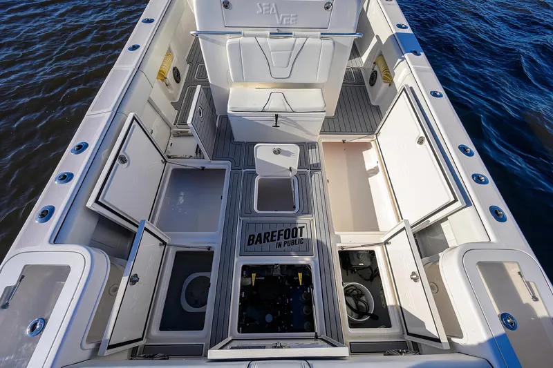 Barefoot In Public Yacht Photos Pics 2023 SeaVee 370Z boat interior with open storage compartments, on water.