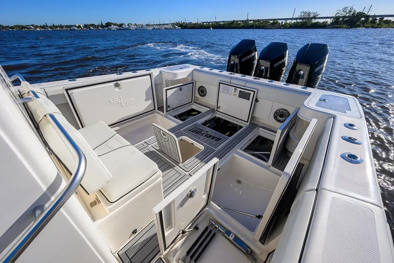Barefoot In Public Yacht Photos Pics 2023 SeaVee 370Z boat interior with open storage compartments and triple Mercury engines.