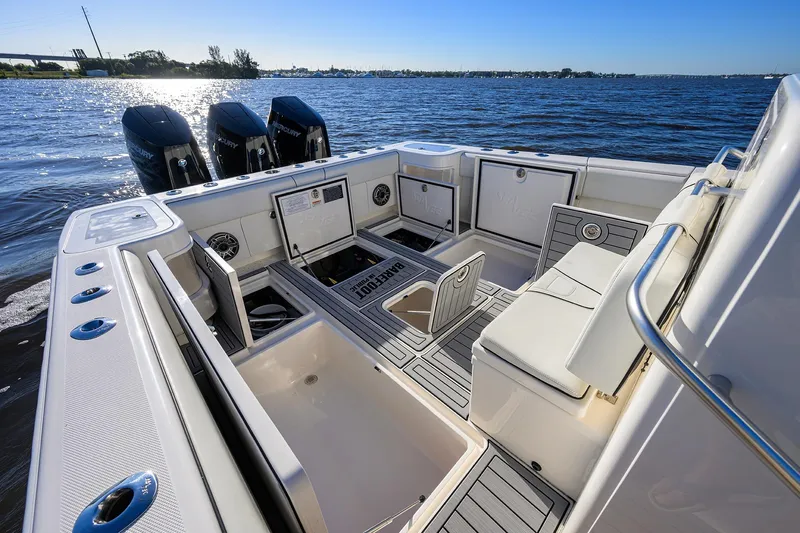 Barefoot In Public Yacht Photos Pics 2023 SeaVee 370Z boat interior with triple Mercury engines on a sunny day.