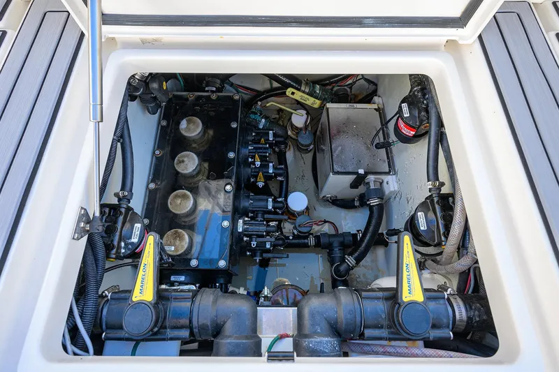 Barefoot In Public Yacht Photos Pics Engine compartment of 2023 SeaVee 370Z boat, showcasing mechanical components and wiring.
