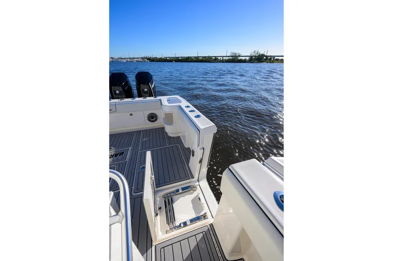 Barefoot In Public Yacht Photos Pics 2023 SeaVee 370Z boat deck with ocean view, featuring sleek design and powerful engines.