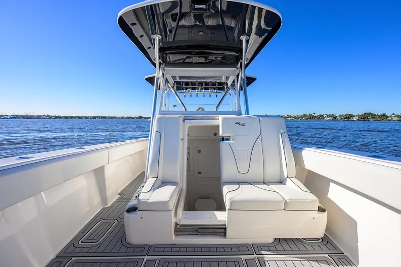 Barefoot In Public Yacht Photos Pics 2023 SeaVee 370Z boat interior with seating, on a sunny day at sea.