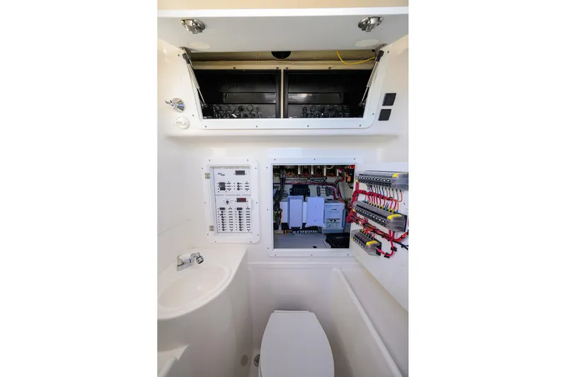 Barefoot In Public Yacht Photos Pics 2023 SeaVee 370Z boat interior with electrical panel and compact bathroom setup.