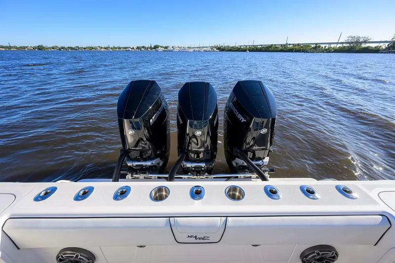 Barefoot In Public Yacht Photos Pics 2023 SeaVee 370Z boat with triple Mercury outboard engines on a calm waterway.