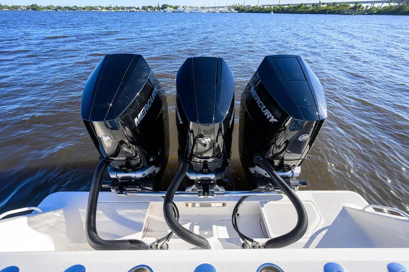 Barefoot In Public Yacht Photos Pics 2023 SeaVee 370Z boat with triple Mercury outboard engines on a calm waterway.