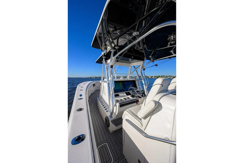 Barefoot In Public Yacht Photos Pics 2023 SeaVee 370Z boat interior with helm, white seating, and ocean view.