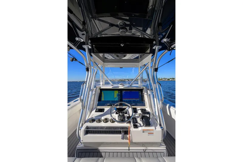 Barefoot In Public Yacht Photos Pics 2023 SeaVee 370Z boat helm with advanced navigation system on open water.