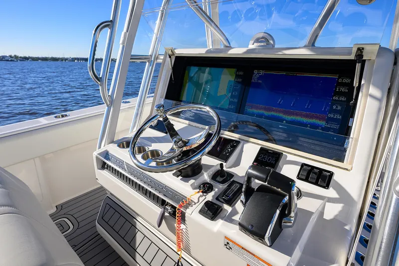 Barefoot In Public Yacht Photos Pics 2023 SeaVee 370Z boat helm with advanced navigation system and steering wheel.