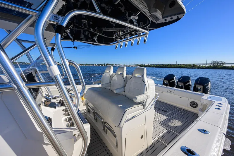 Barefoot In Public Yacht Photos Pics 2023 SeaVee 370Z boat interior with seating and multiple outboard engines on a sunny day.
