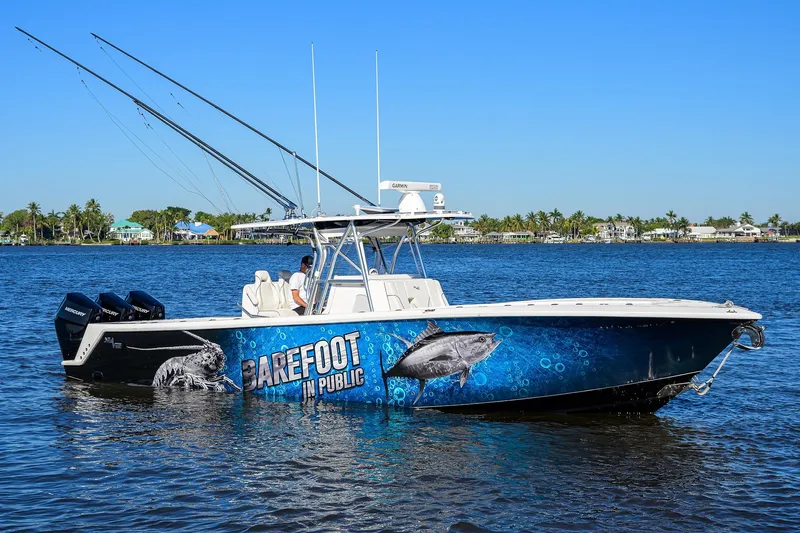 Barefoot In Public Yacht Photos Pics 2023 SeaVee 370Z boat on water with vibrant fish-themed graphics.