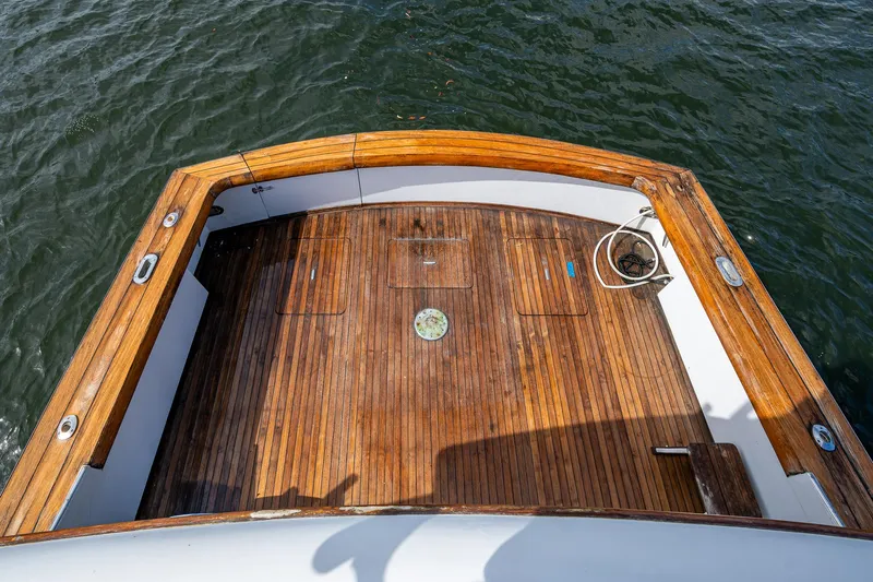 Able Hand Yacht Photos Pics Wooden deck of a 1978 Graves 51 boat, overlooking the water.